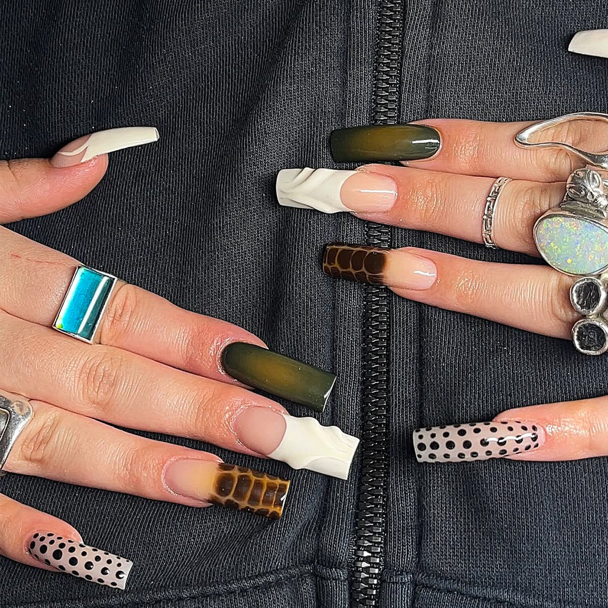 Model wearing olive green 3D long square press-on nails with mixed pattern details