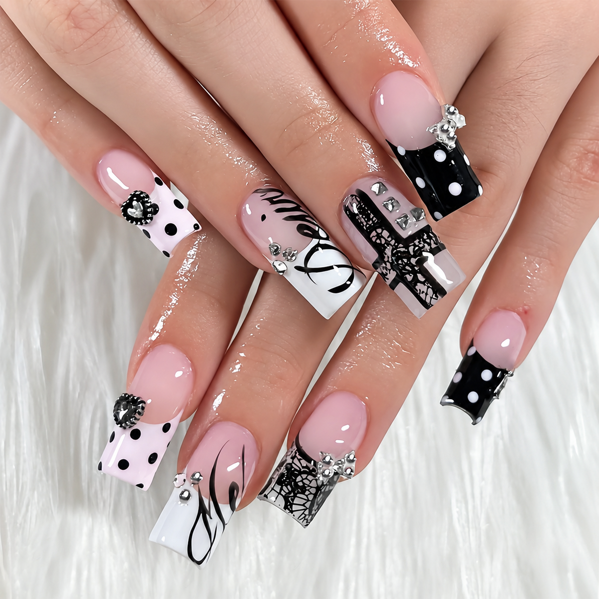 Model wearing peacock blue French square press-on nails with polka dot details
