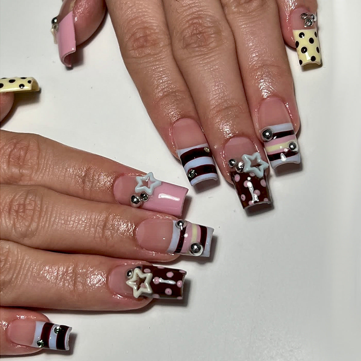 Model wearing sky blue Y2K star square press-on nails with abstract wave details